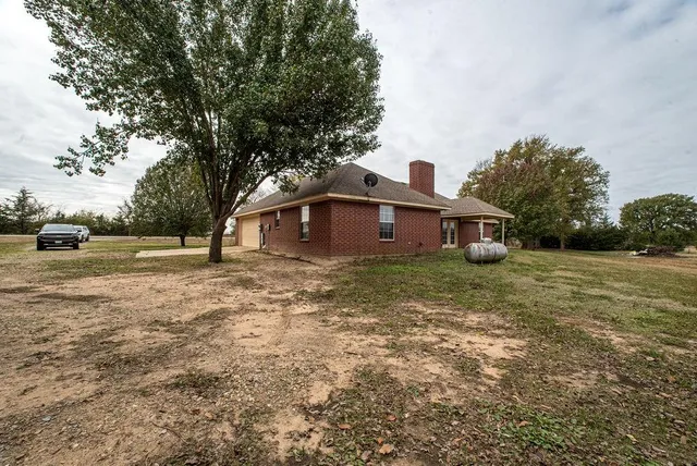 a front view of house with yard and green space