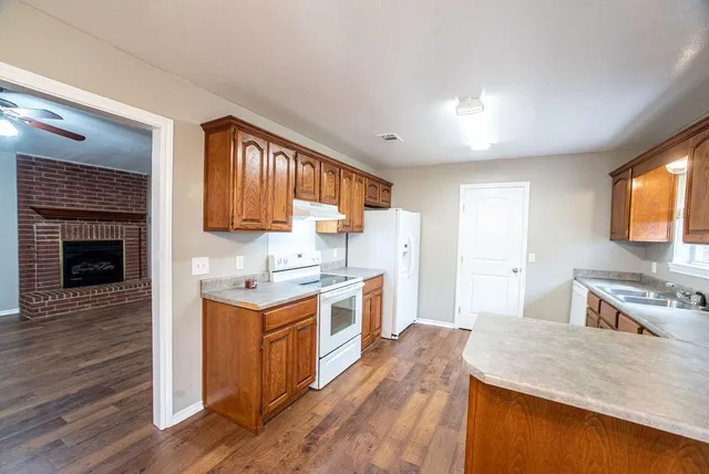 a kitchen with a stove top oven sink and cabinets