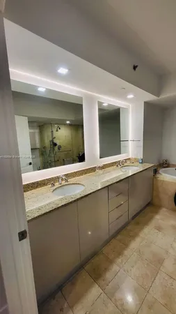 a bathroom with a granite countertop sink mirror and