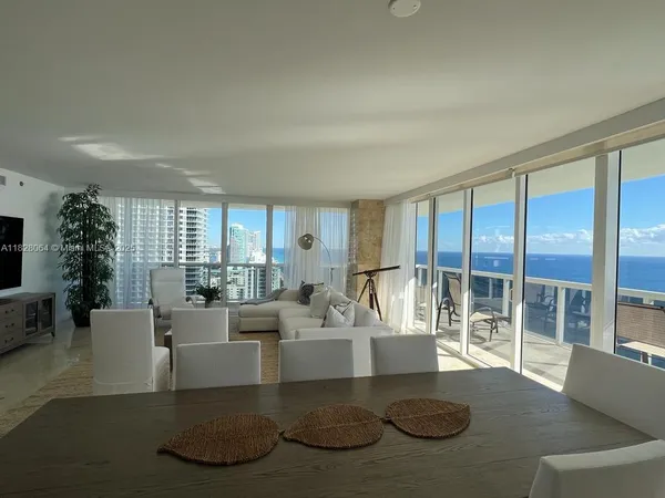 a living room with furniture granite floor and a large window