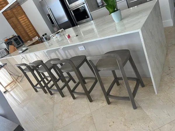 a view of an chairs and table in the kitchen