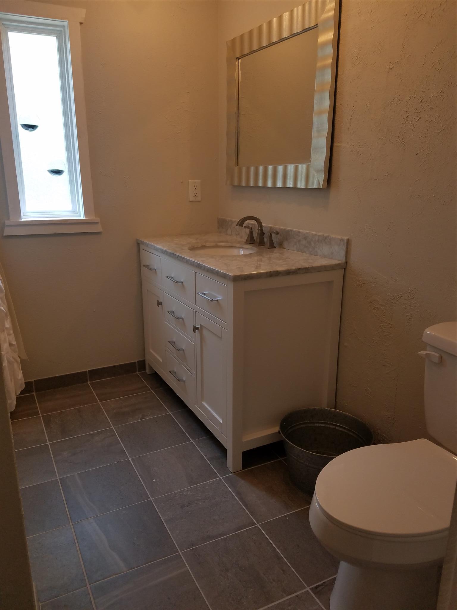 305 North Centerpoint Road Portland, TN 37148 - Photo 11 of 18 a bathroom with a toilet sink and mirror