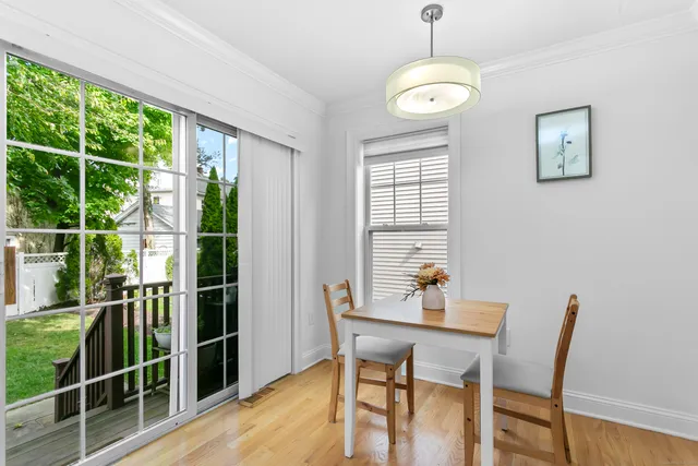 a dining room with furniture and window