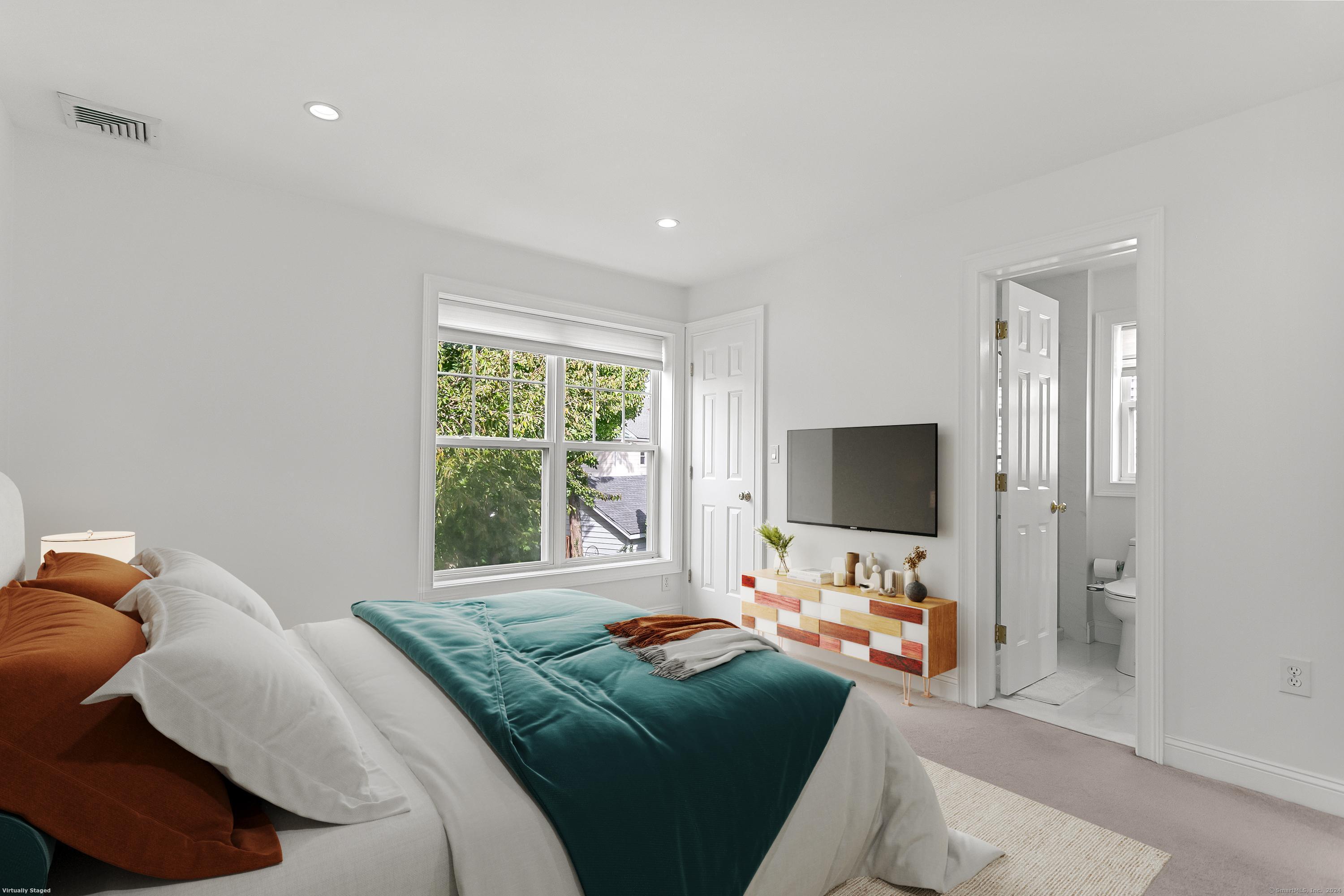 28 Rock Spring Road, Unit B2 Stamford, CT 06906 - Photo 13 of 32 a bedroom with furniture and a flat screen tv