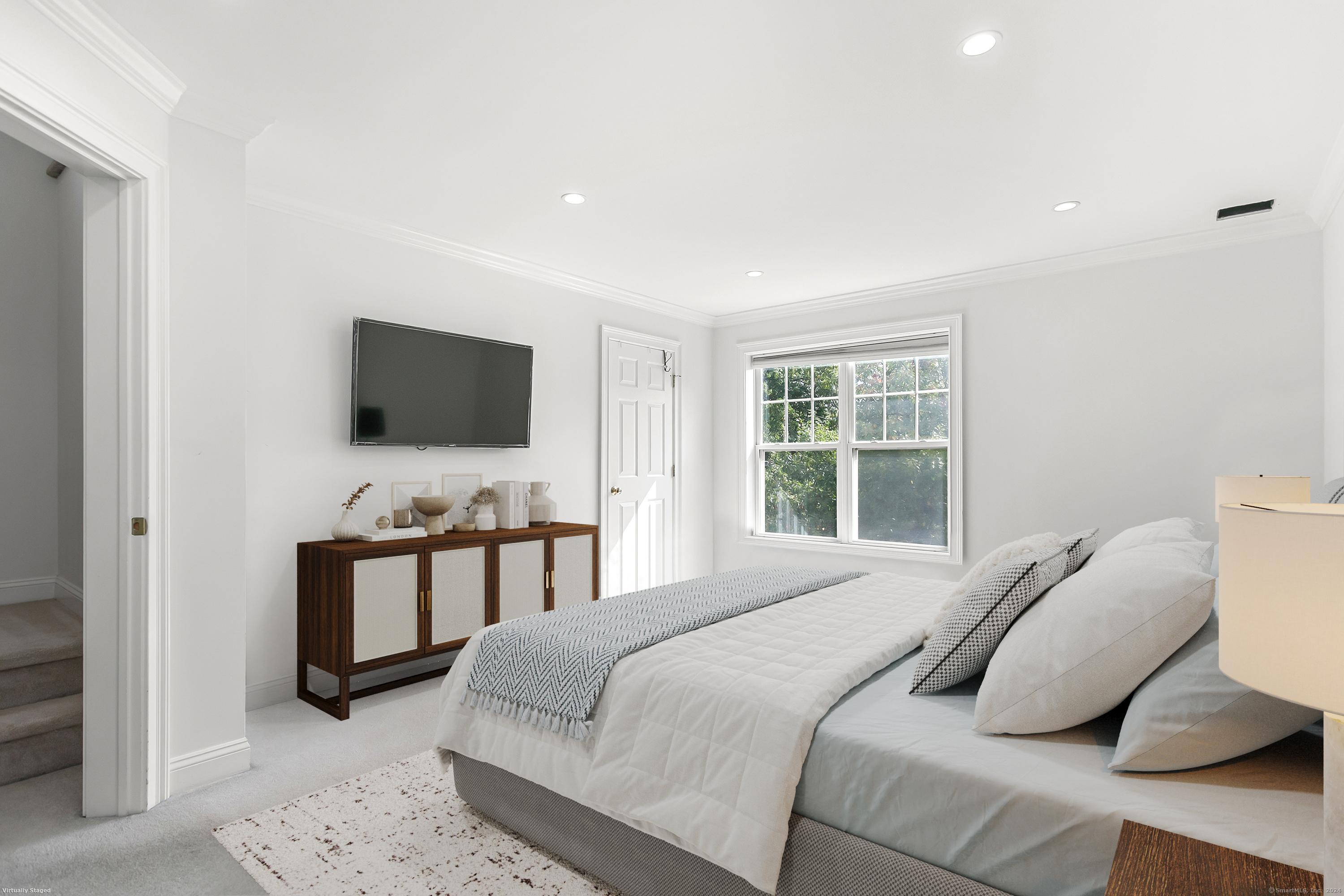 28 Rock Spring Road, Unit B2 Stamford, CT 06906 - Photo 17 of 32 a bedroom with a bed and a flat screen tv