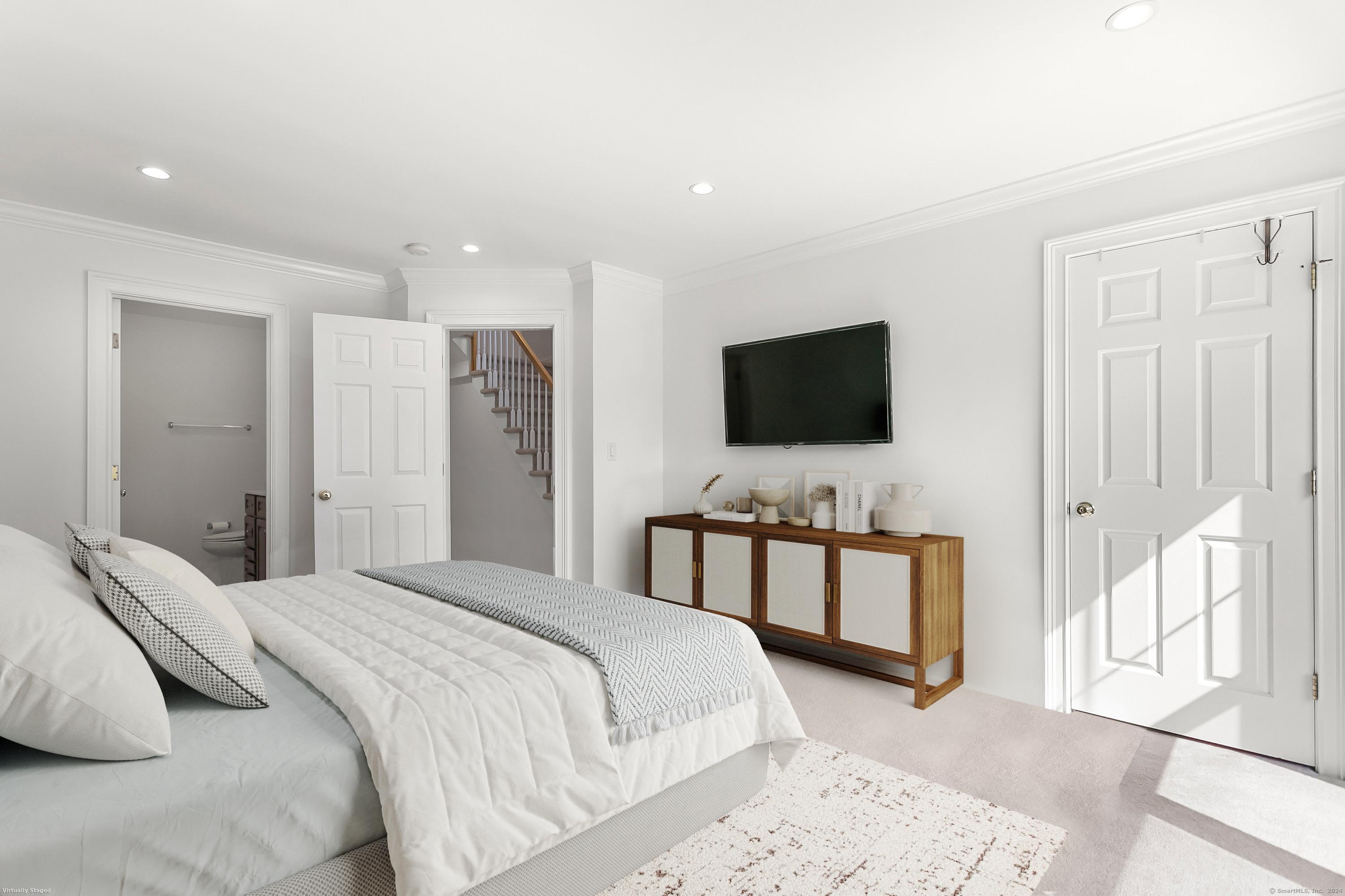 28 Rock Spring Road, Unit B2 Stamford, CT 06906 - Photo 19 of 32 a bedroom with a bed and a flat screen tv