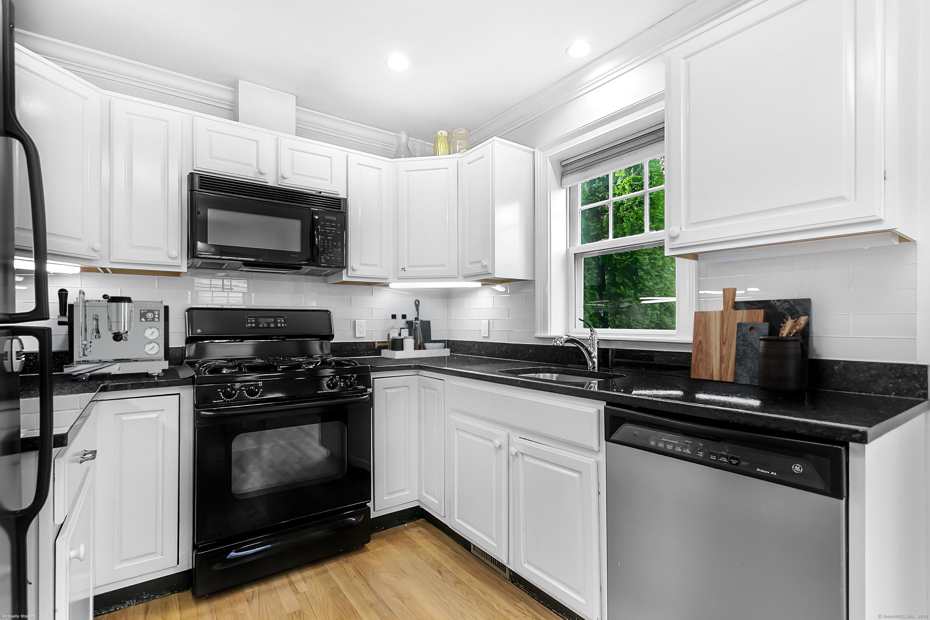 28 Rock Spring Road, Unit B2 Stamford, CT 06906 - Photo 10 of 32 a kitchen with granite countertop a sink cabinets and stainless steel appliances