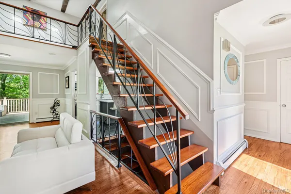 a living room with furniture and stairs