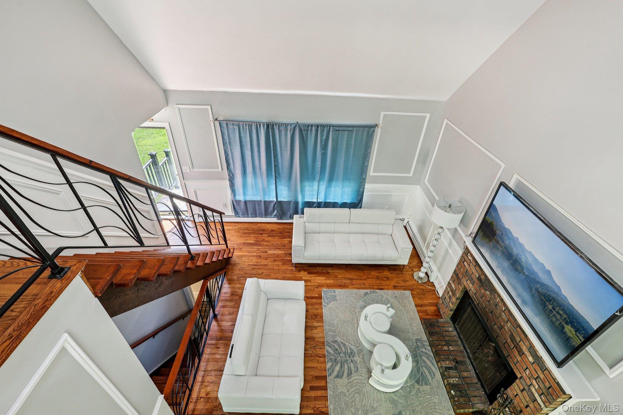 Living area with a brick fireplace and a decorative wall
