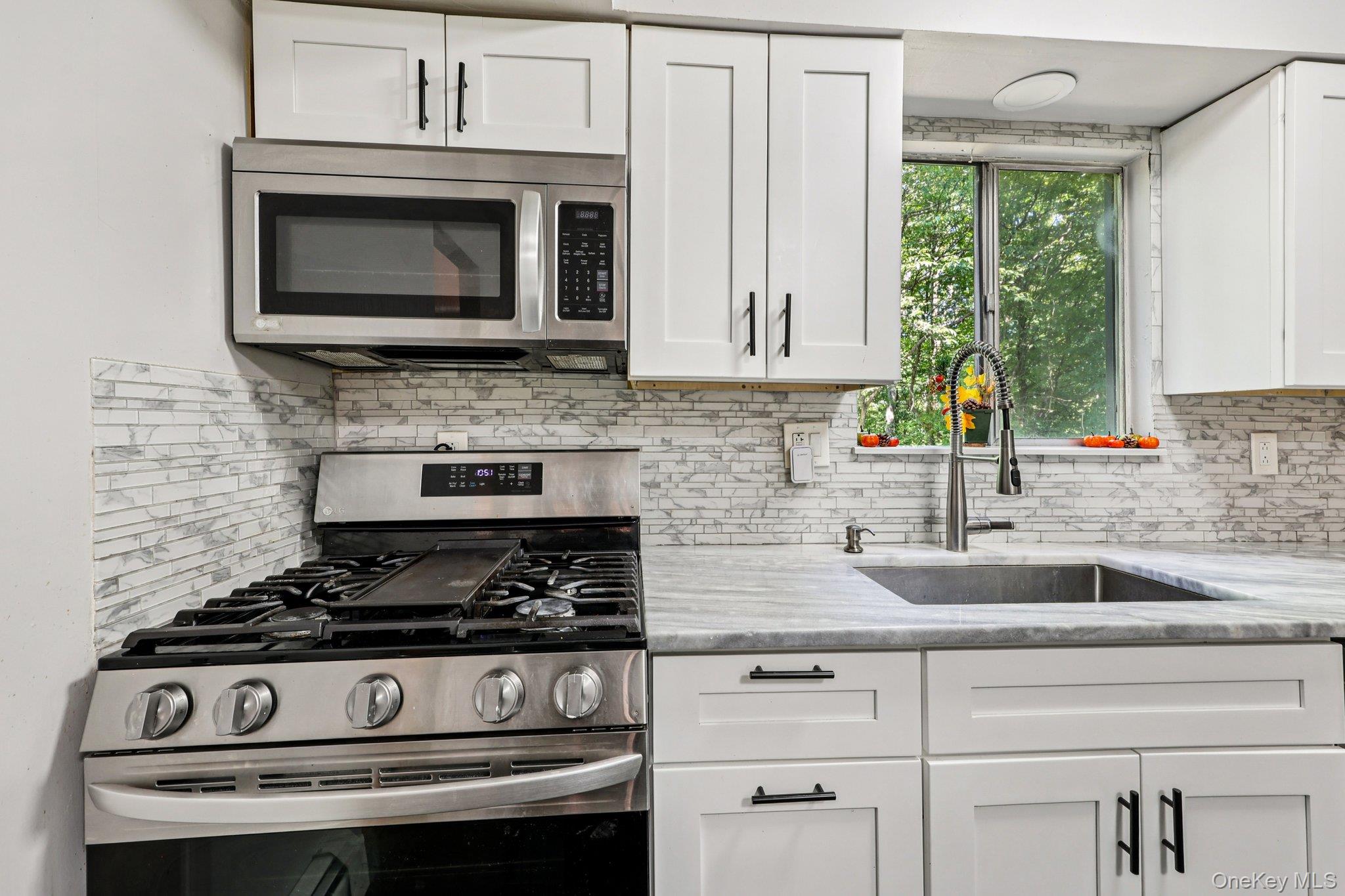 9 Crane Road Middletown, NY 10941 - Photo 13 of 31 Kitchen with white cabinets, stainless steel appliances, and beautiful backsplash