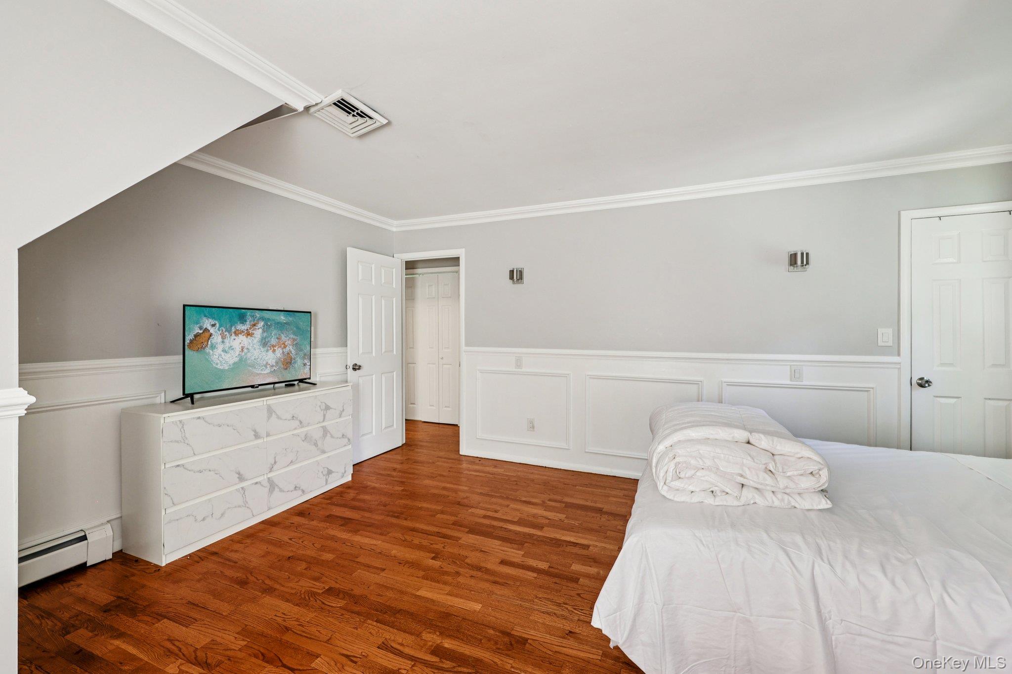 9 Crane Road Middletown, NY 10941 - Photo 17 of 31 Bedroom featuring crown molding, wood finished floors, and wainscot walls