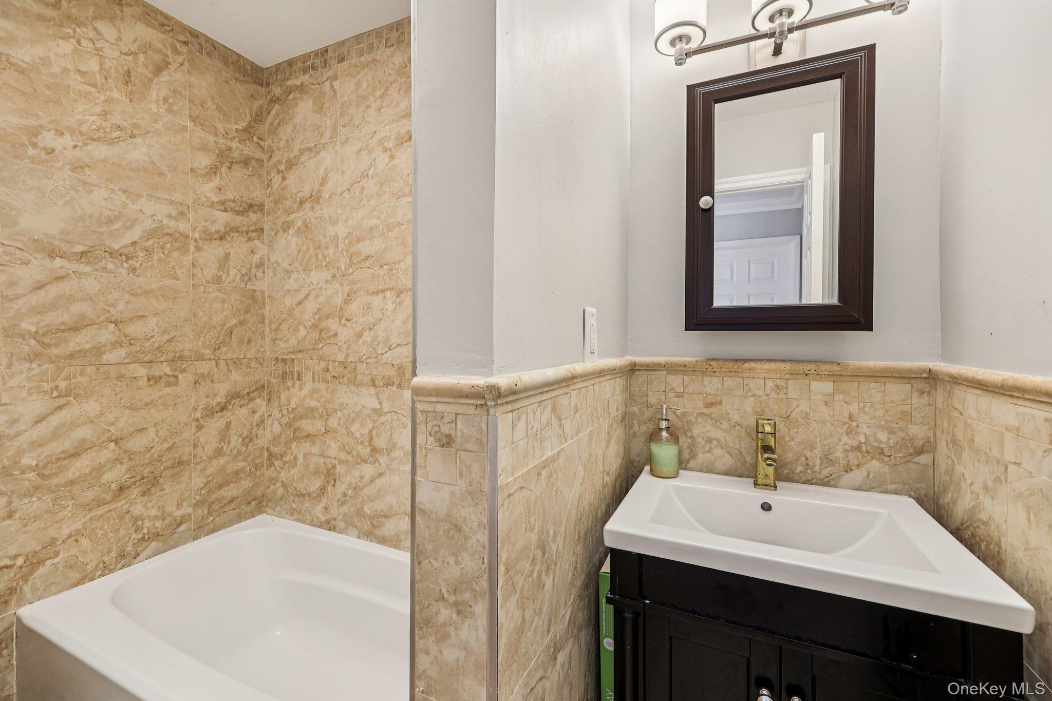 9 Crane Road Middletown, NY 10941 - Photo 21 of 31 Bathroom with tile walls, vanity, shower / tub combination