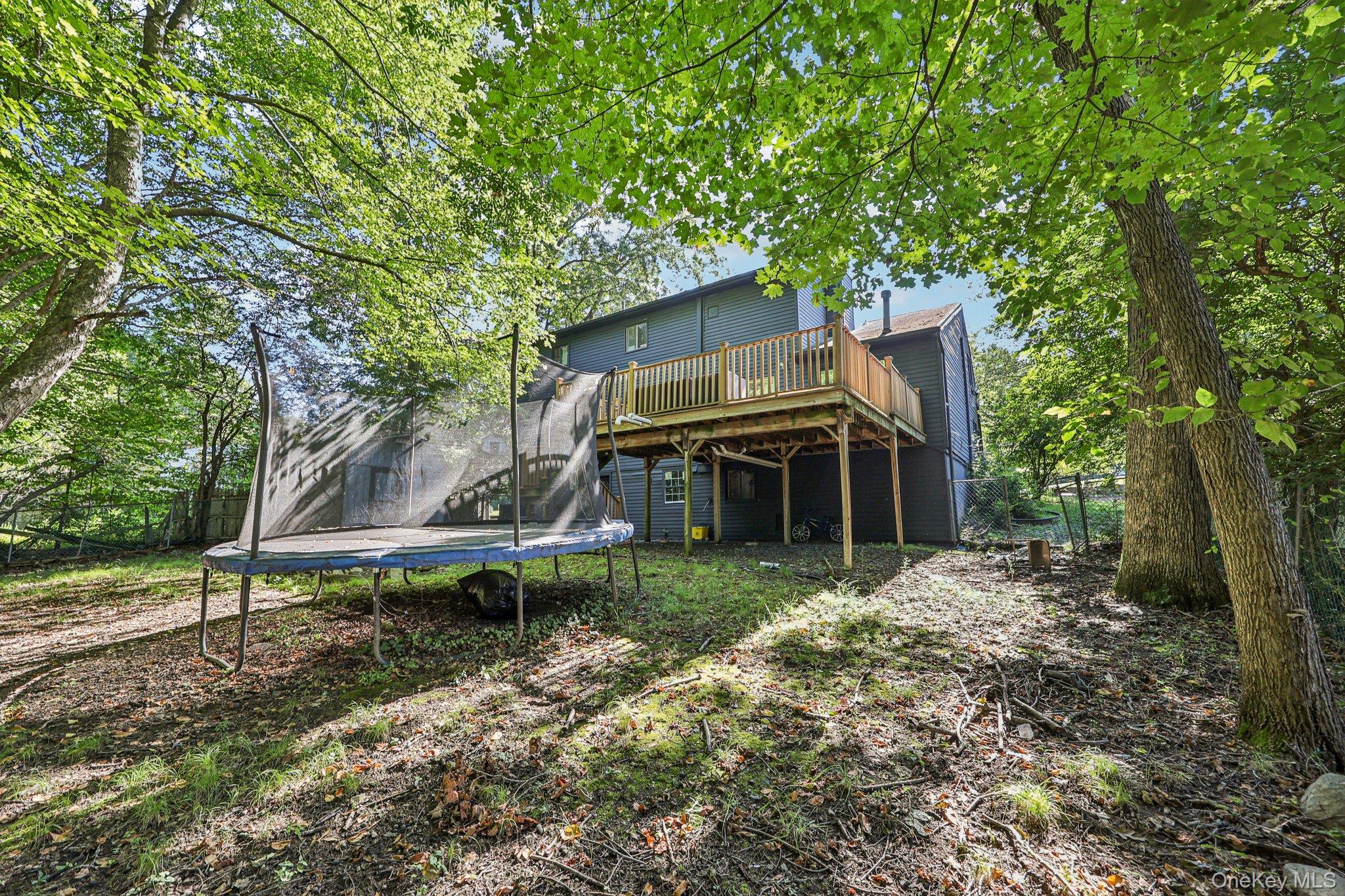 9 Crane Road Middletown, NY 10941 - Photo 23 of 31 Back of property featuring a trampoline and a wooden deck