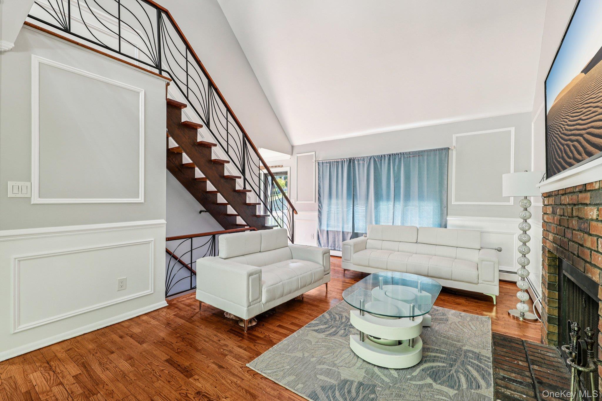 9 Crane Road Middletown, NY 10941 - Photo 5 of 31 Living room featuring wood finished floors, a brick fireplace, and high ceiling