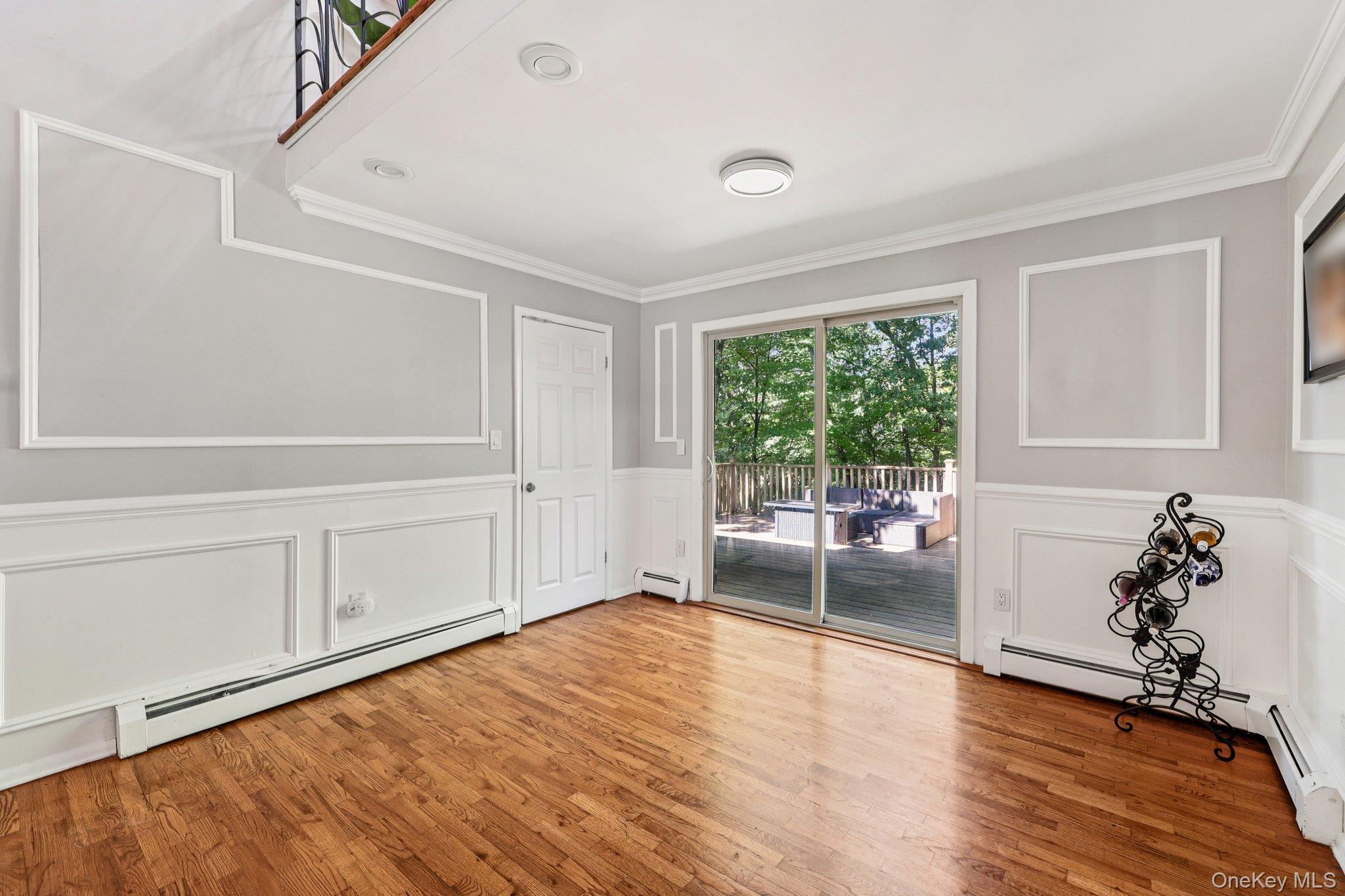 9 Crane Road Middletown, NY 10941 - Photo 5 of 31 Unfurnished dining area with wood finished floors, crown molding and wainscot walls