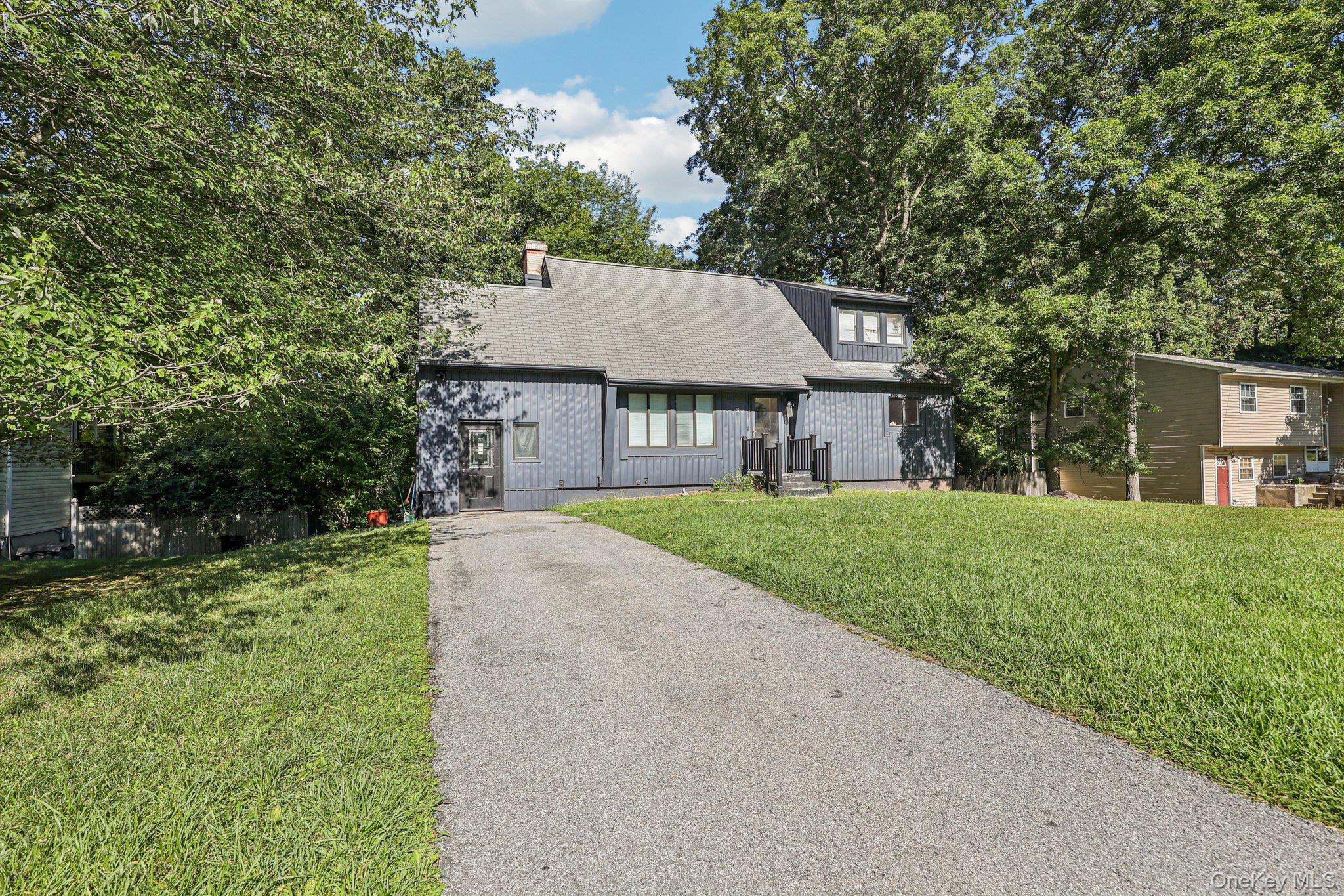 9 Crane Road Middletown, NY 10941 - Photo 8 of 31 View of front of home featuring a front lawn, driveway, a shingled roof, and a chimney