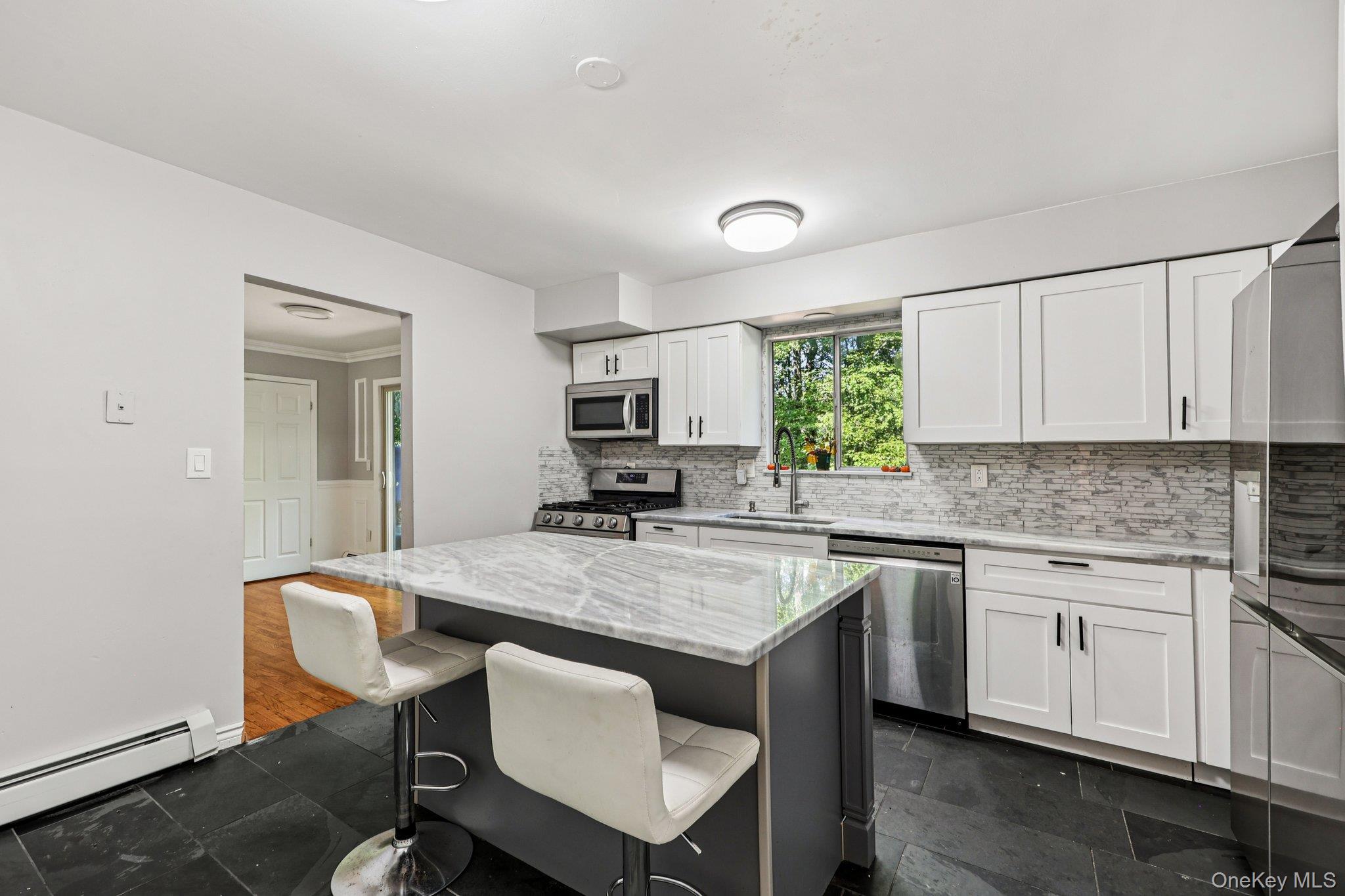 9 Crane Road Middletown, NY 10941 - Photo 10 of 31 Kitchen with white cabinets, stainless steel appliances, and beautiful backsplash