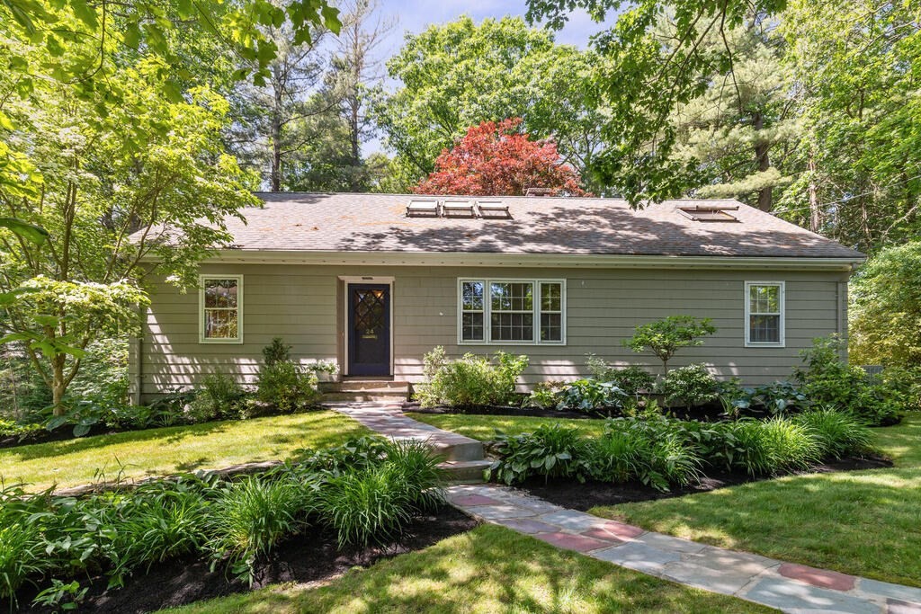 a front view of house with yard and green space