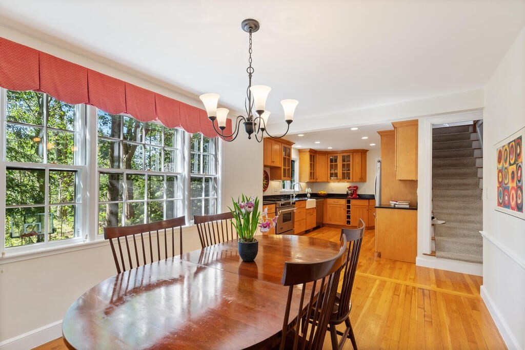 24 Blake Road Lexington, MA 02420 - Photo 18 of 30 a view of a dining room with furniture a chandelier and large windows