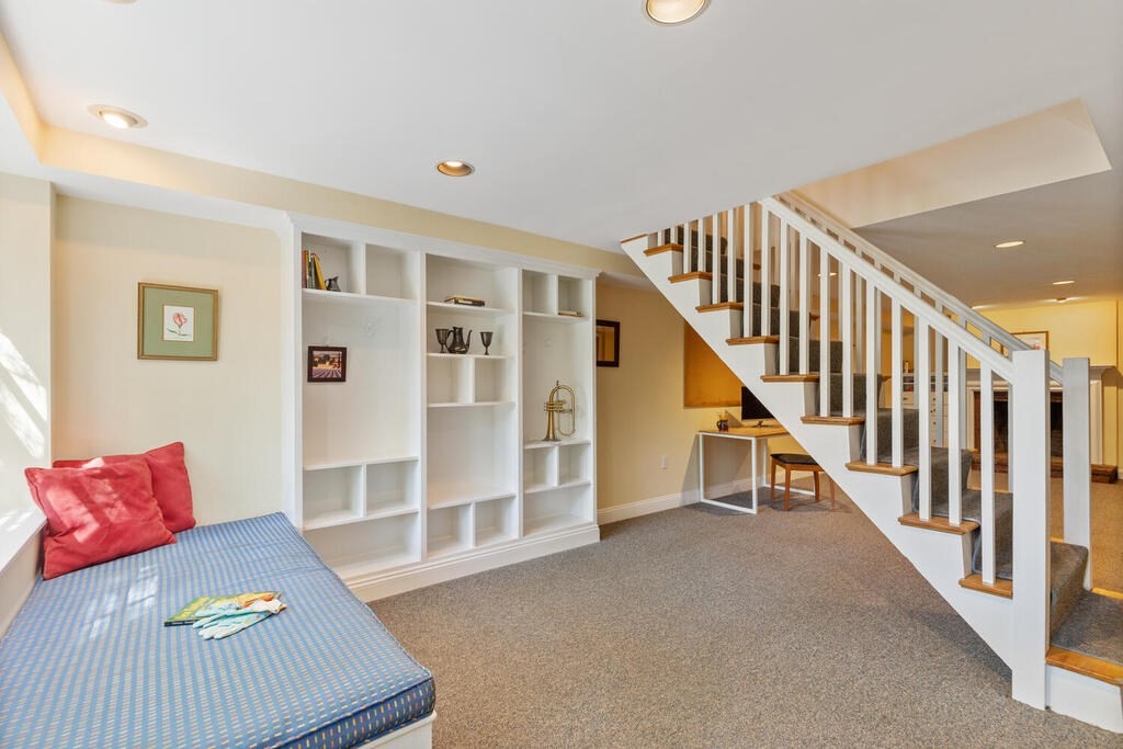24 Blake Road Lexington, MA 02420 - Photo 28 of 30 a living room with stairs and a couch