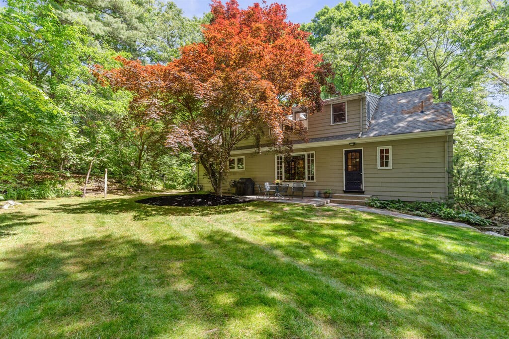24 Blake Road Lexington, MA 02420 - Photo 29 of 30 a backyard of a house with yard table and chairs