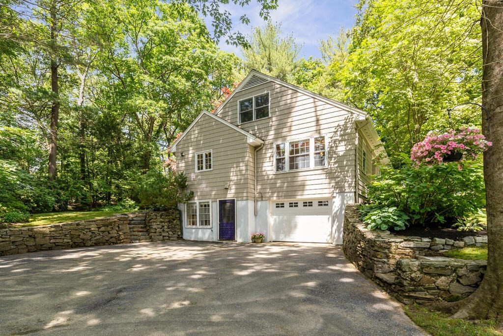 24 Blake Road Lexington, MA 02420 - Photo 3 of 30 a front view of a house with a yard and garage