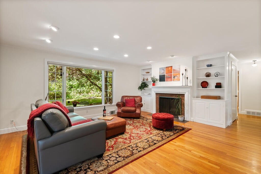 24 Blake Road Lexington, MA 02420 - Photo 4 of 30 a living room with furniture a fireplace and wooden floor