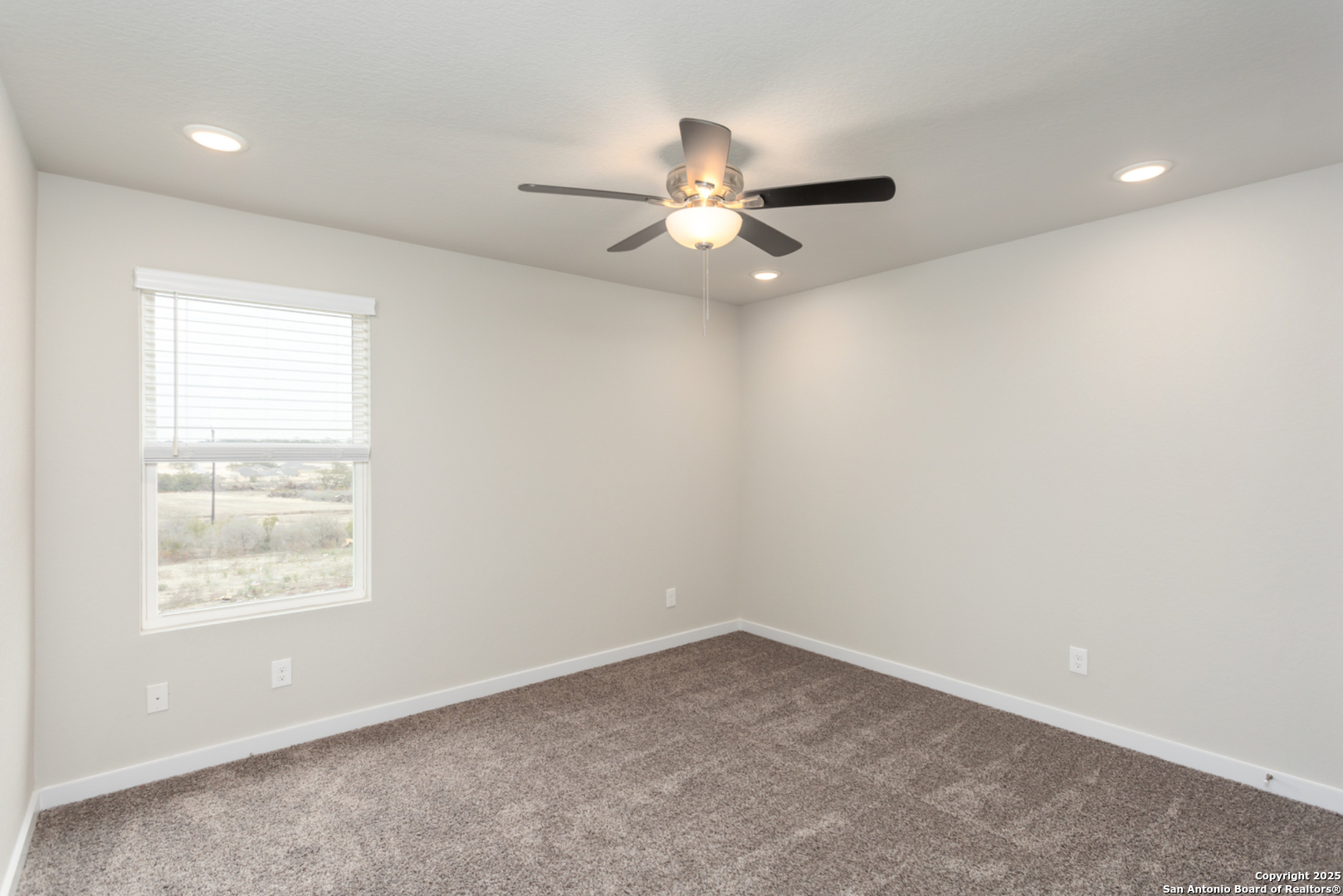 380 Abigail Alley San Antonio, TX 78253 - Photo 11 of 22 an empty room with a window and a fan