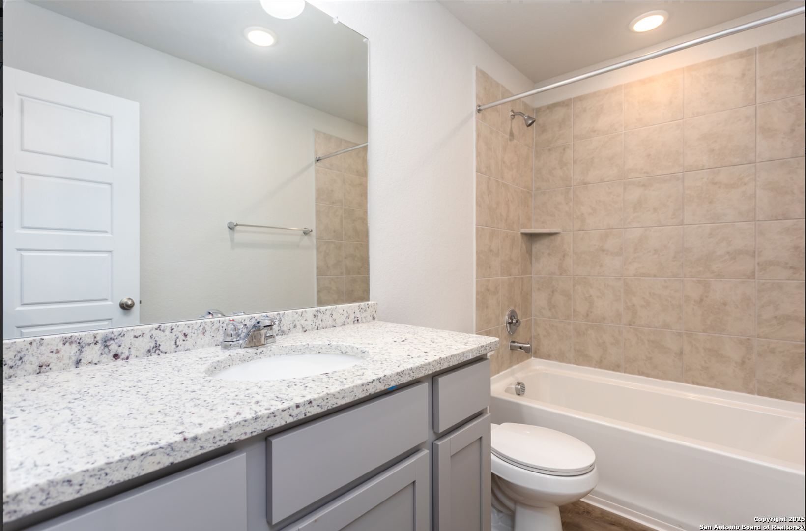 380 Abigail Alley San Antonio, TX 78253 - Photo 16 of 22 a bathroom with a granite countertop sink a toilet and shower