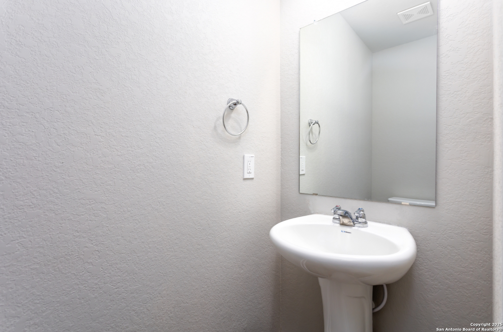 380 Abigail Alley San Antonio, TX 78253 - Photo 19 of 22 a bathroom with a sink and mirror