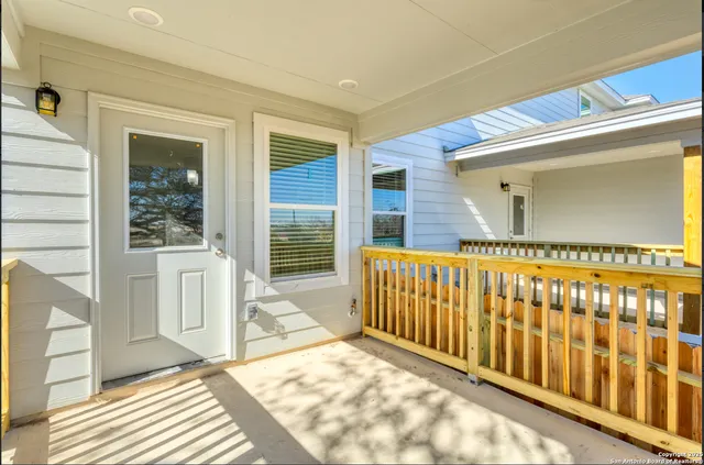 a view of a porch with a table and chairs