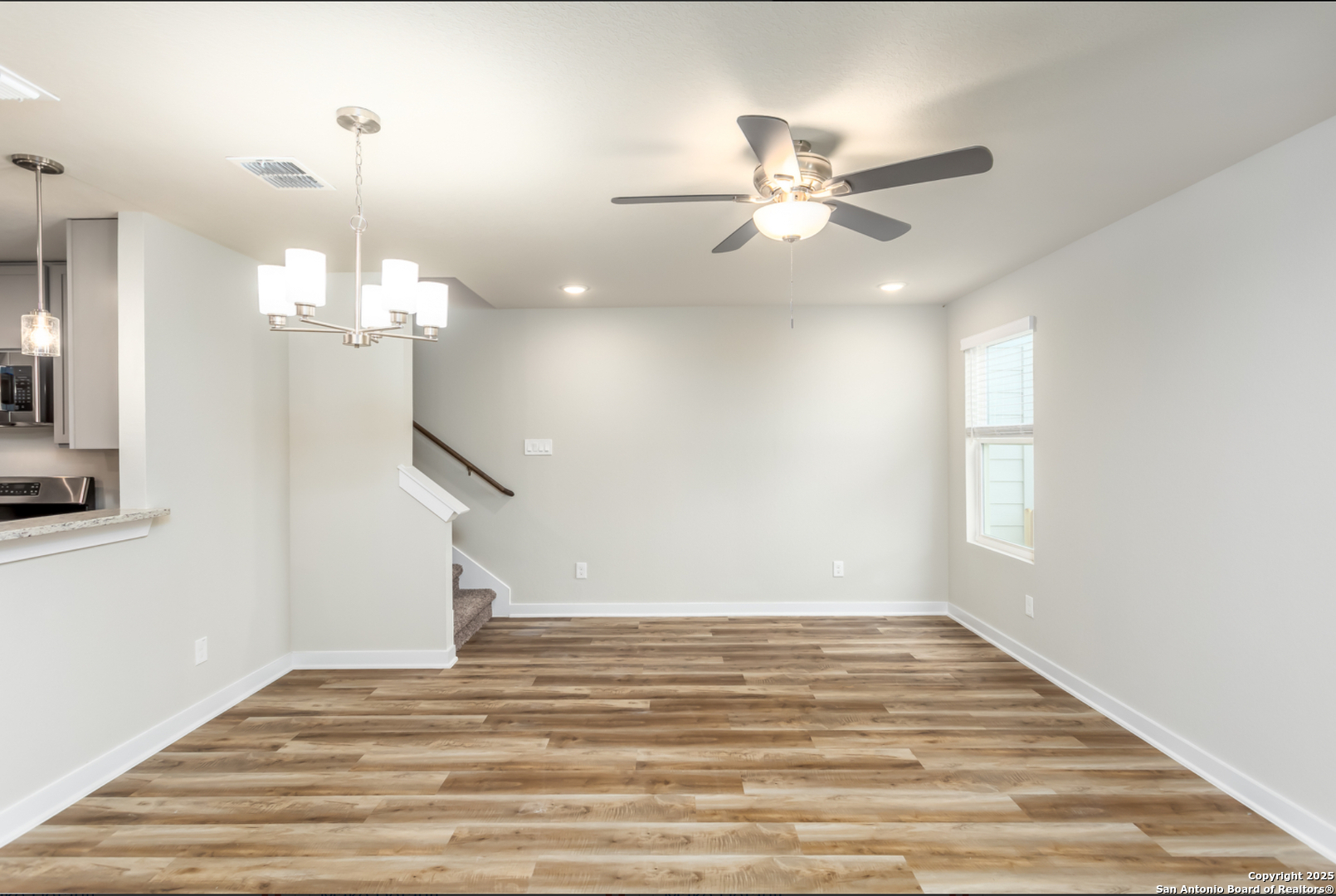 380 Abigail Alley San Antonio, TX 78253 - Photo 3 of 22 a view of a chandelier fan and wooden floor