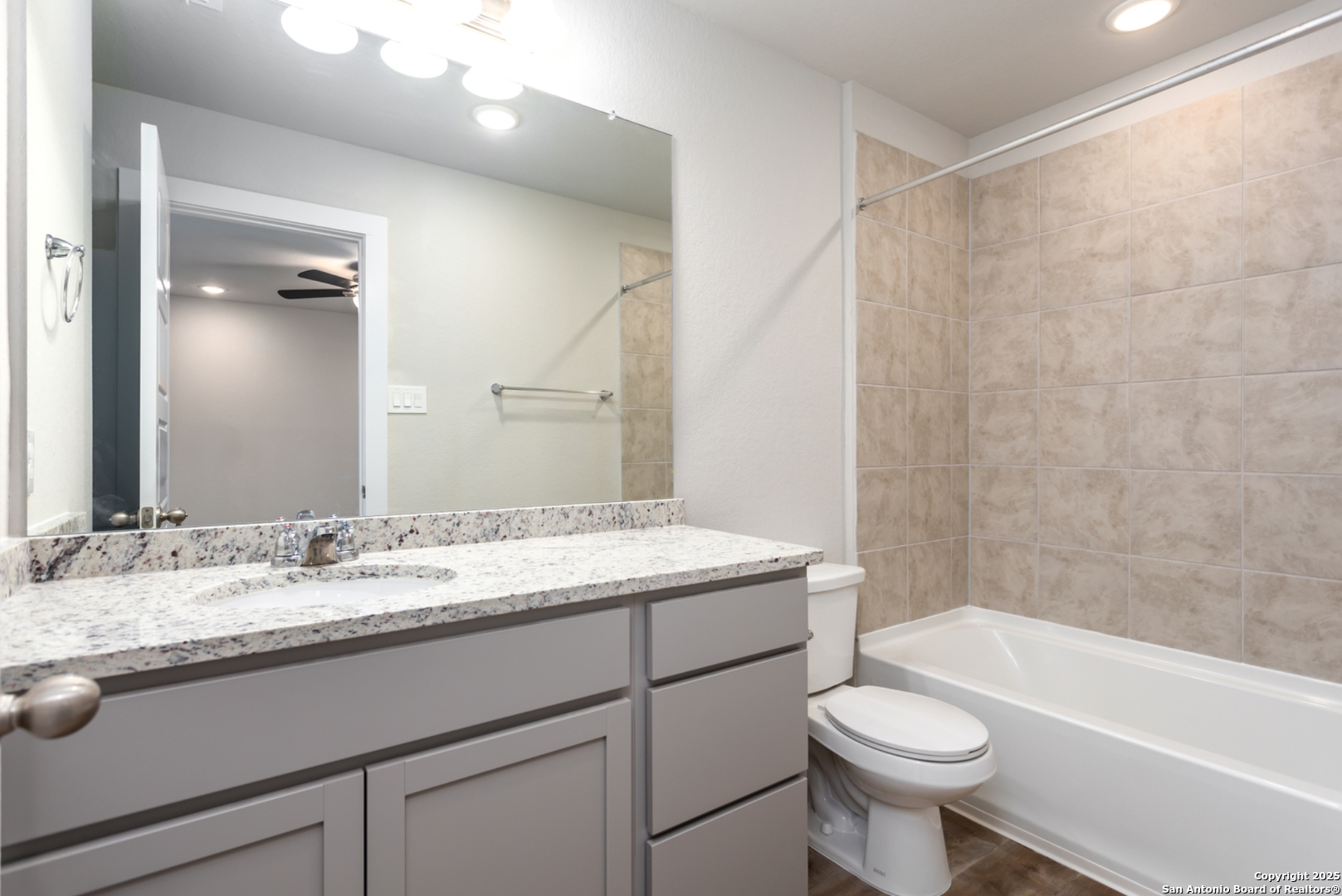 380 Abigail Alley San Antonio, TX 78253 - Photo 9 of 22 a bathroom with a sink a toilet a mirror a bathtub and shower