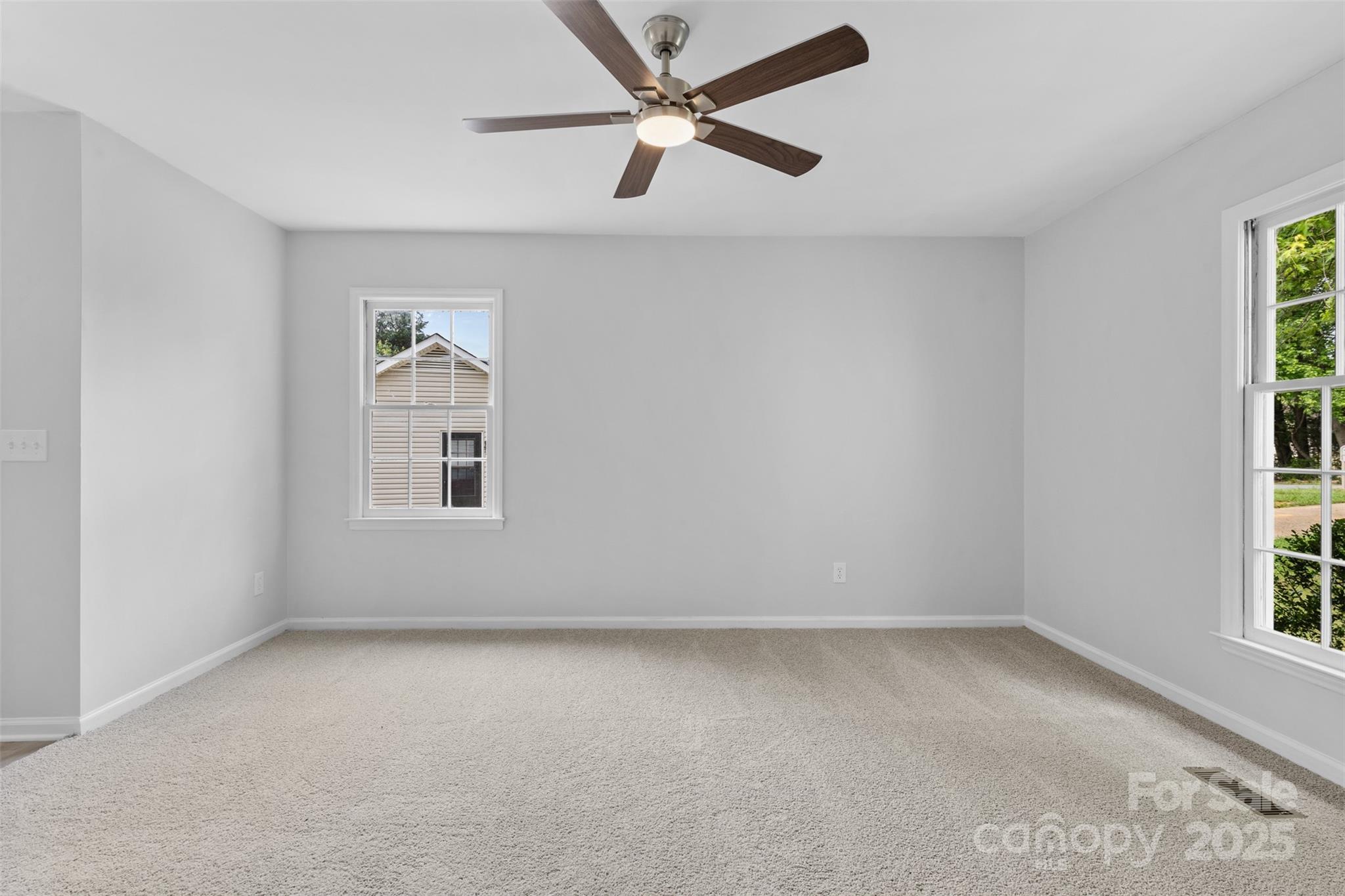 6412 Sullins Road Charlotte, NC 28214 - Photo 16 of 25 an empty room with windows and fan