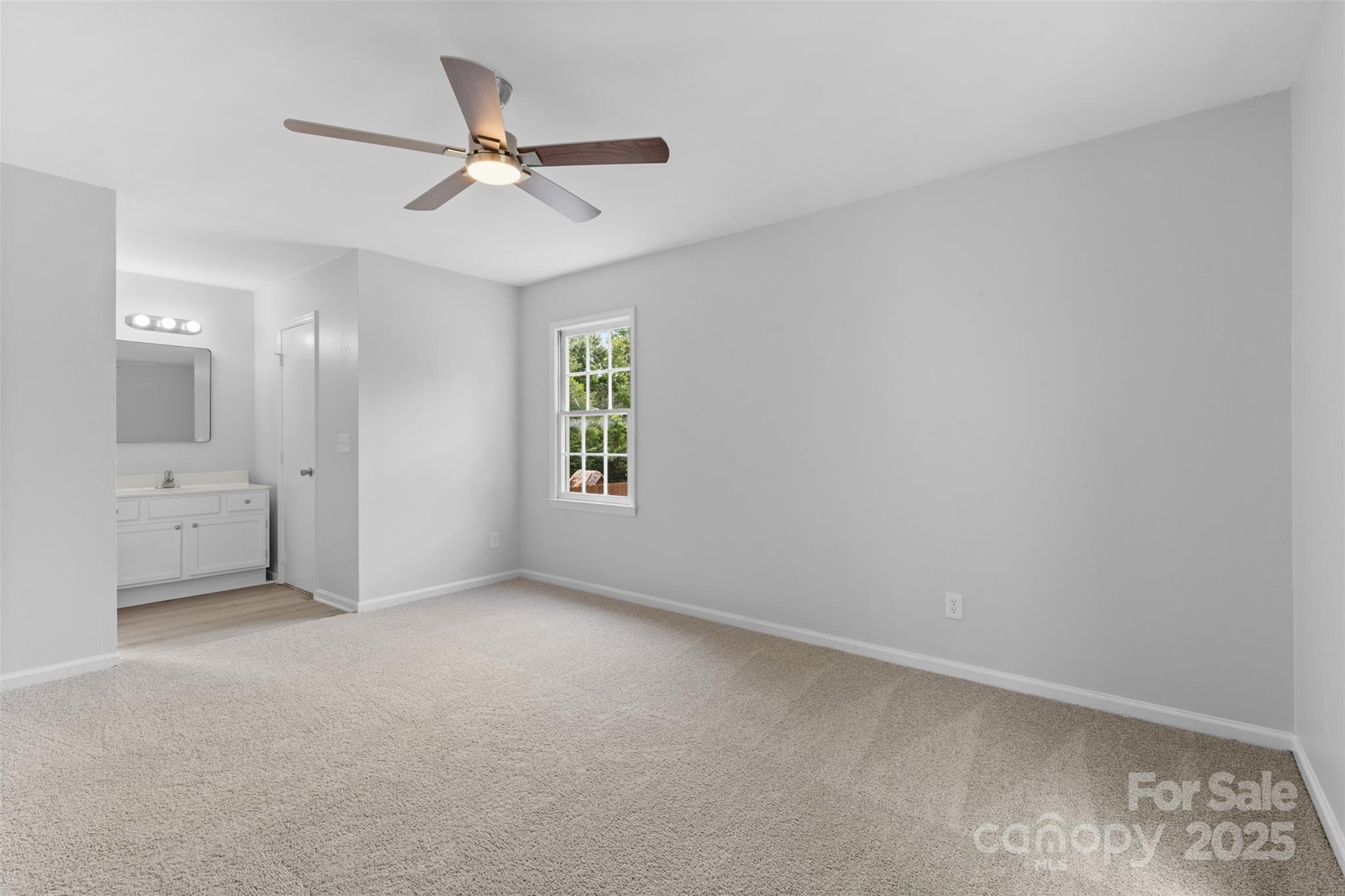 6412 Sullins Road Charlotte, NC 28214 - Photo 17 of 25 an empty room with windows and a ceiling fan