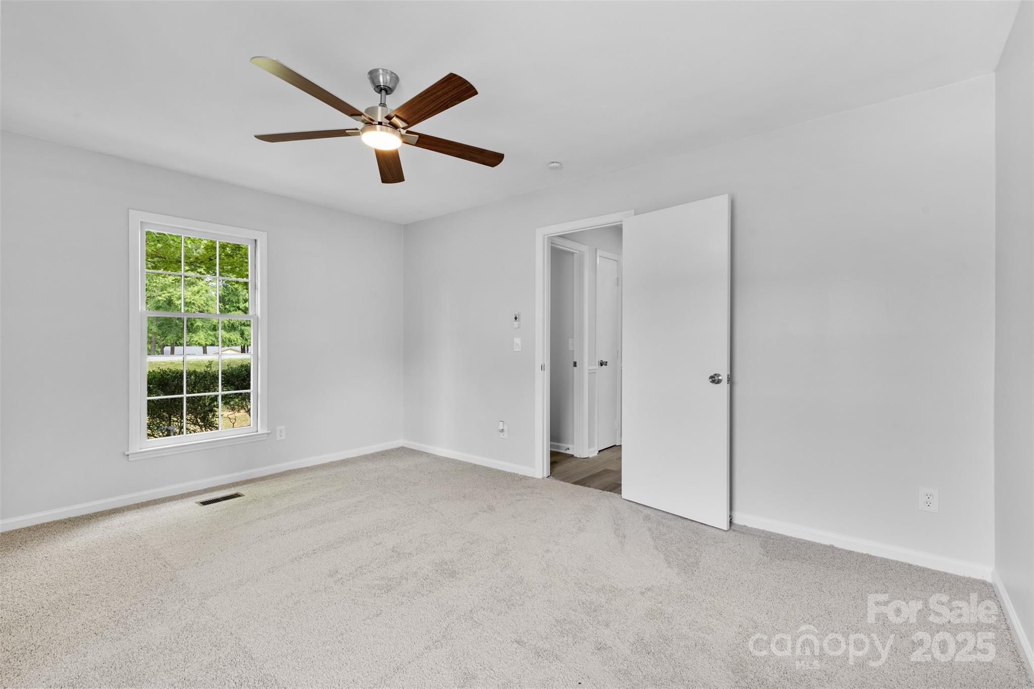 6412 Sullins Road Charlotte, NC 28214 - Photo 18 of 25 an empty room with ceiling fan and window