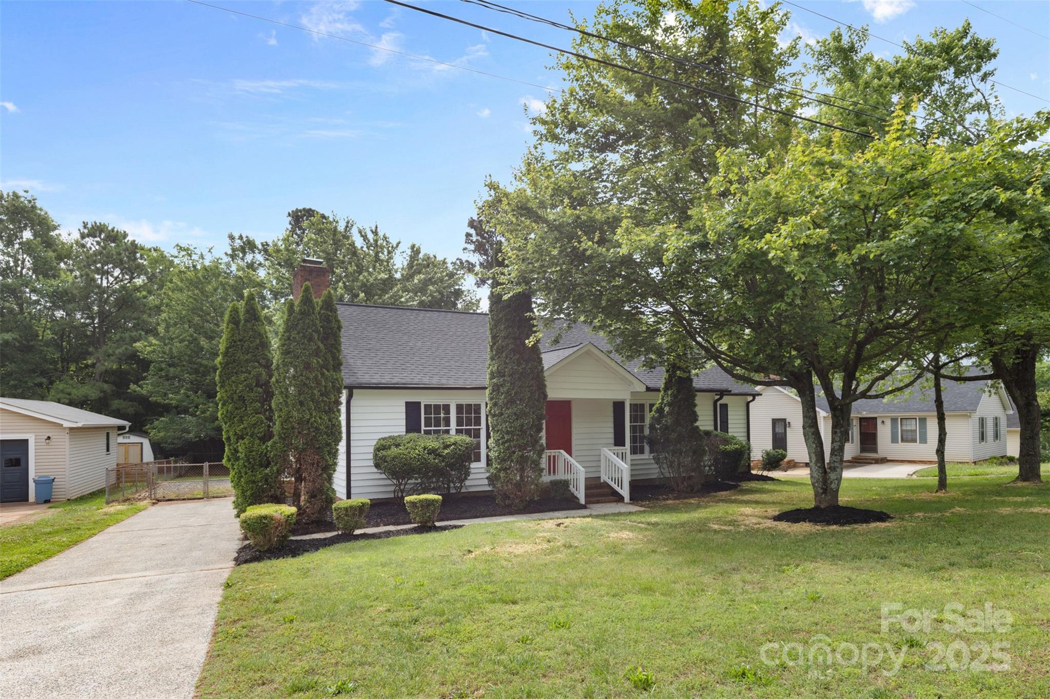 6412 Sullins Road Charlotte, NC 28214 - Photo 2 of 25 a view of a house with a patio and a yard
