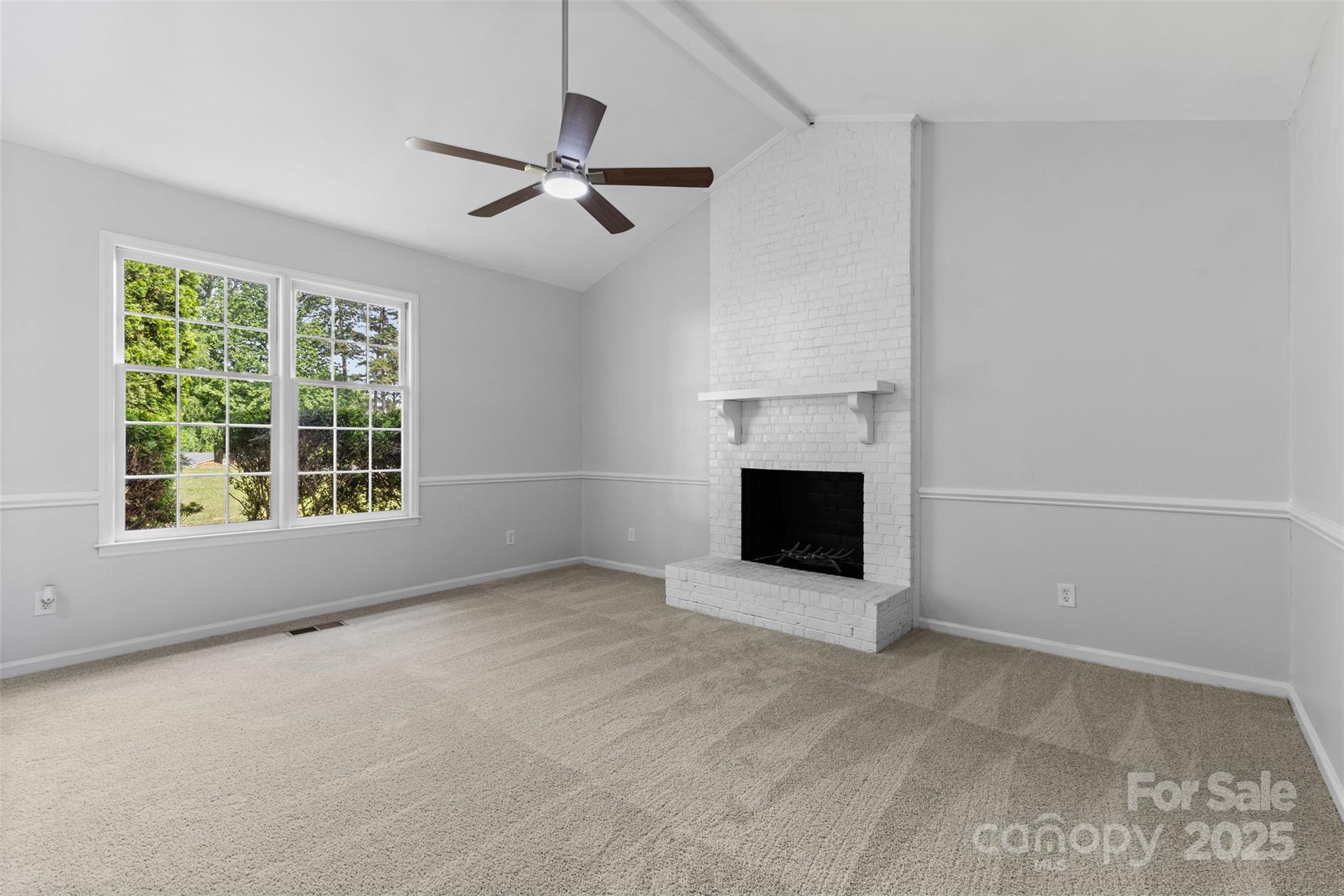 6412 Sullins Road Charlotte, NC 28214 - Photo 6 of 25 a view of an empty room with a fireplace and a window