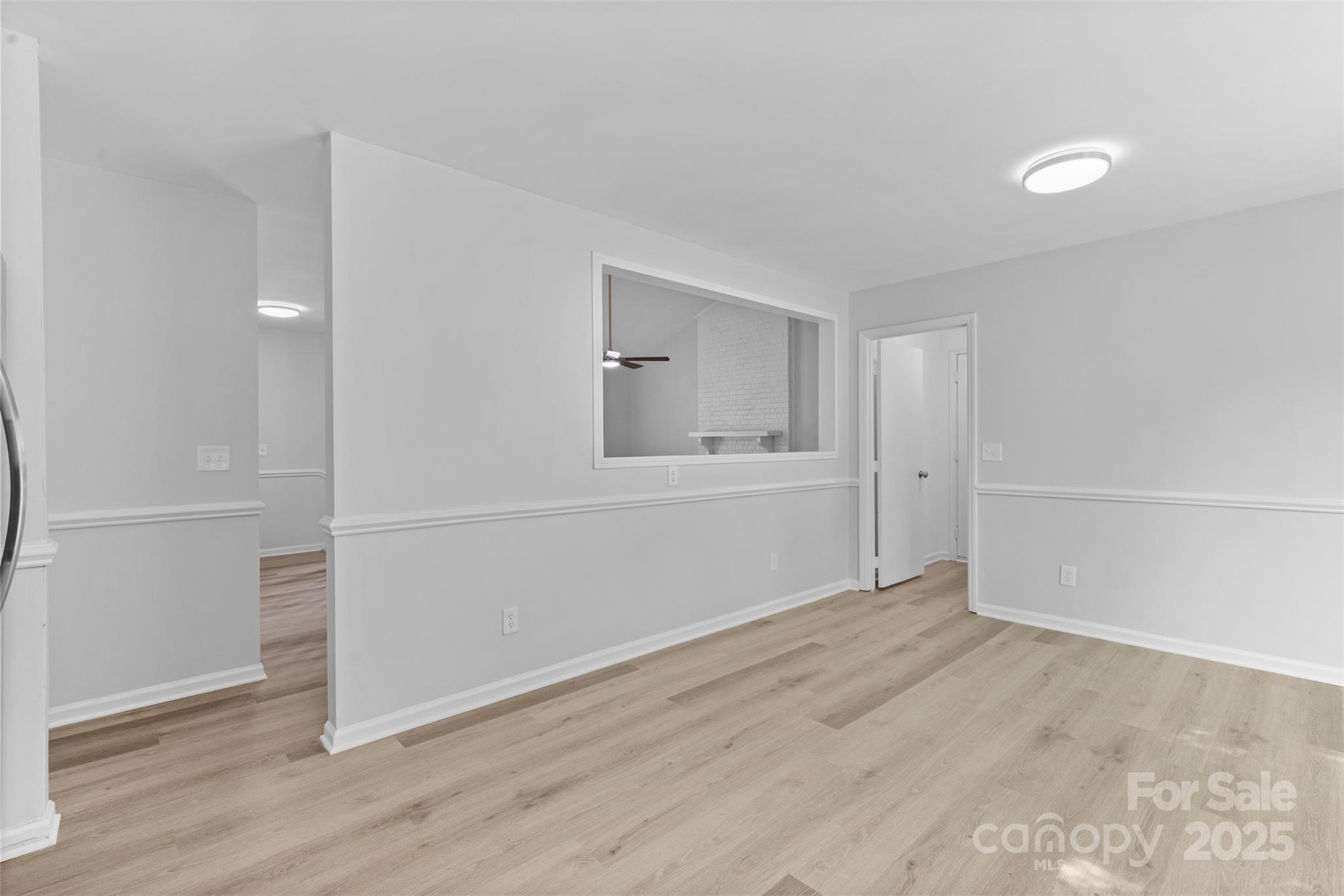 6412 Sullins Road Charlotte, NC 28214 - Photo 10 of 25 an empty room with wooden floor and mirror