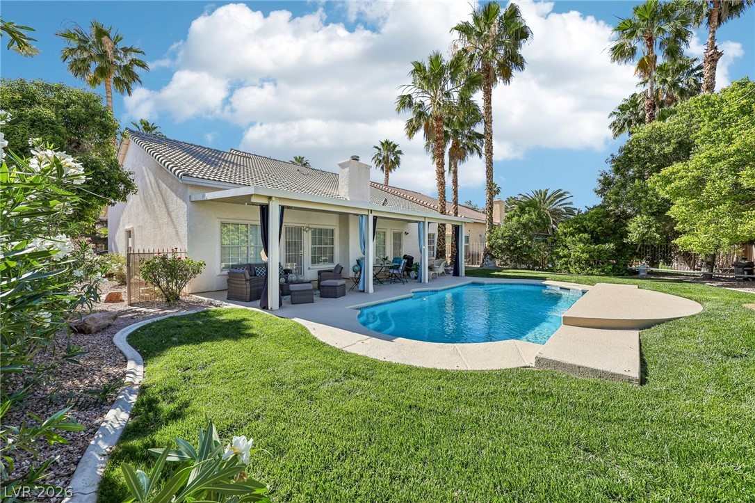 5236 Saranac Road Las Vegas, NV 89130 - Photo 45 of 52 This spacious backyard oasis features a beautiful swimming pool and a covered patio, perfect for outdoor living.