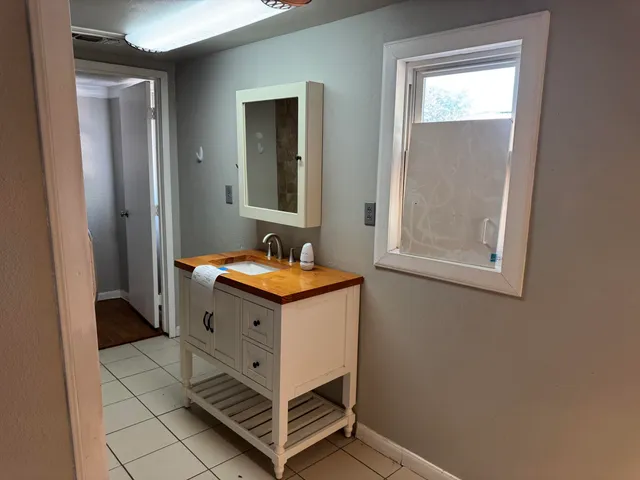 a kitchen with granite countertop stainless steel appliances cabinets a sink and a counter space