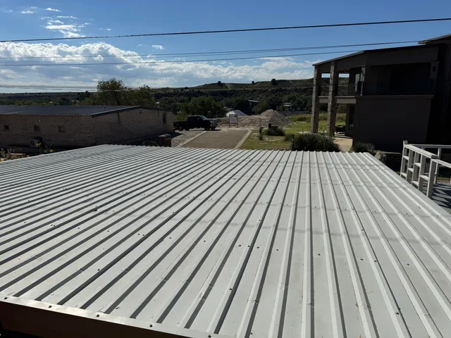 a view of a balcony with wooden floor and fence