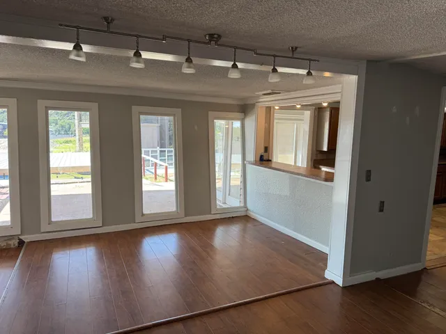 a view of a hallway with wooden floor