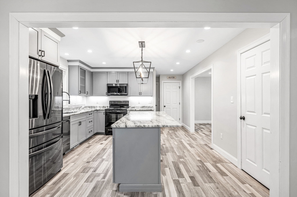 1310 North Brookfield Road Oakham, MA 01068 - Photo 16 of 30 a kitchen with refrigerator cabinets and wooden floor
