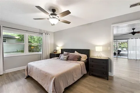 a bedroom with a large bed and a large window