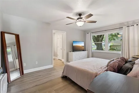 a living room with a bed furniture and a large window