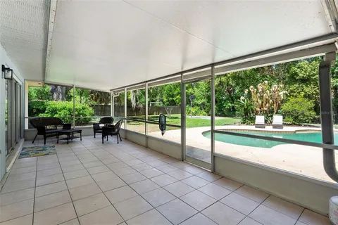 a view of a porch with chairs and backyard