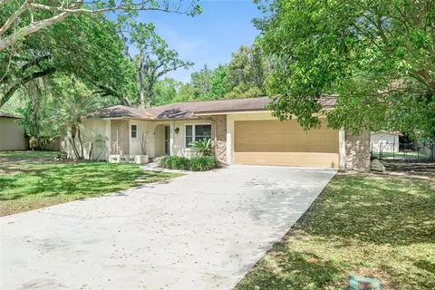 a front view of a house with a yard and a garage