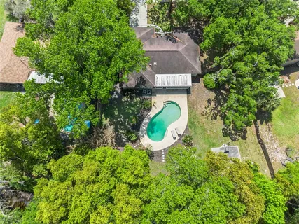 an aerial view of a house with a yard basket ball court and outdoor seating