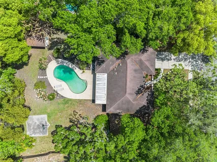 an aerial view of a house with a swimming pool